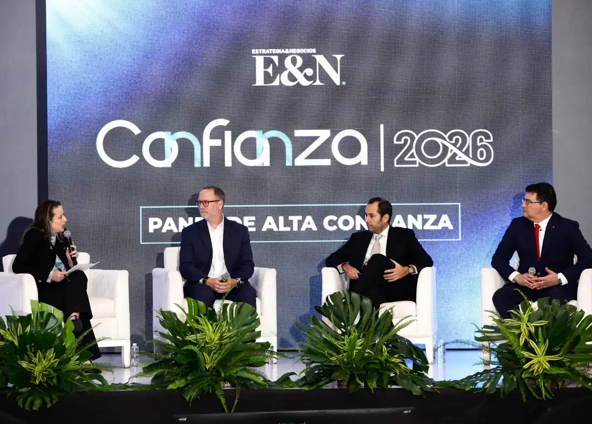 Cuatro profesionales sentados en sillones blancos participando en un panel de discusión empresarial frente a una pantalla con el texto E&N Confianza 2026.