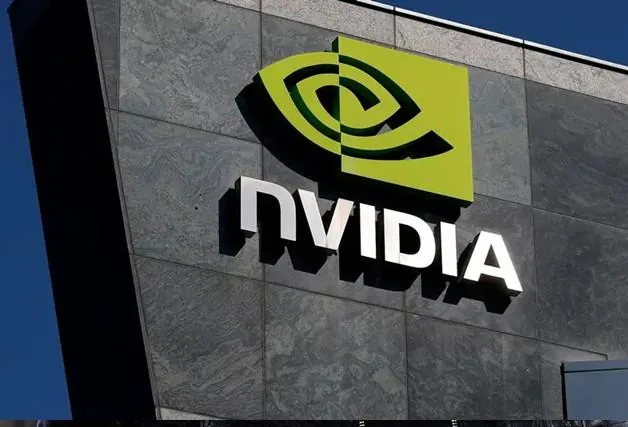 Logotipo oficial de la empresa Nvidia instalado en la fachada de piedra de un edificio corporativo bajo el cielo azul.