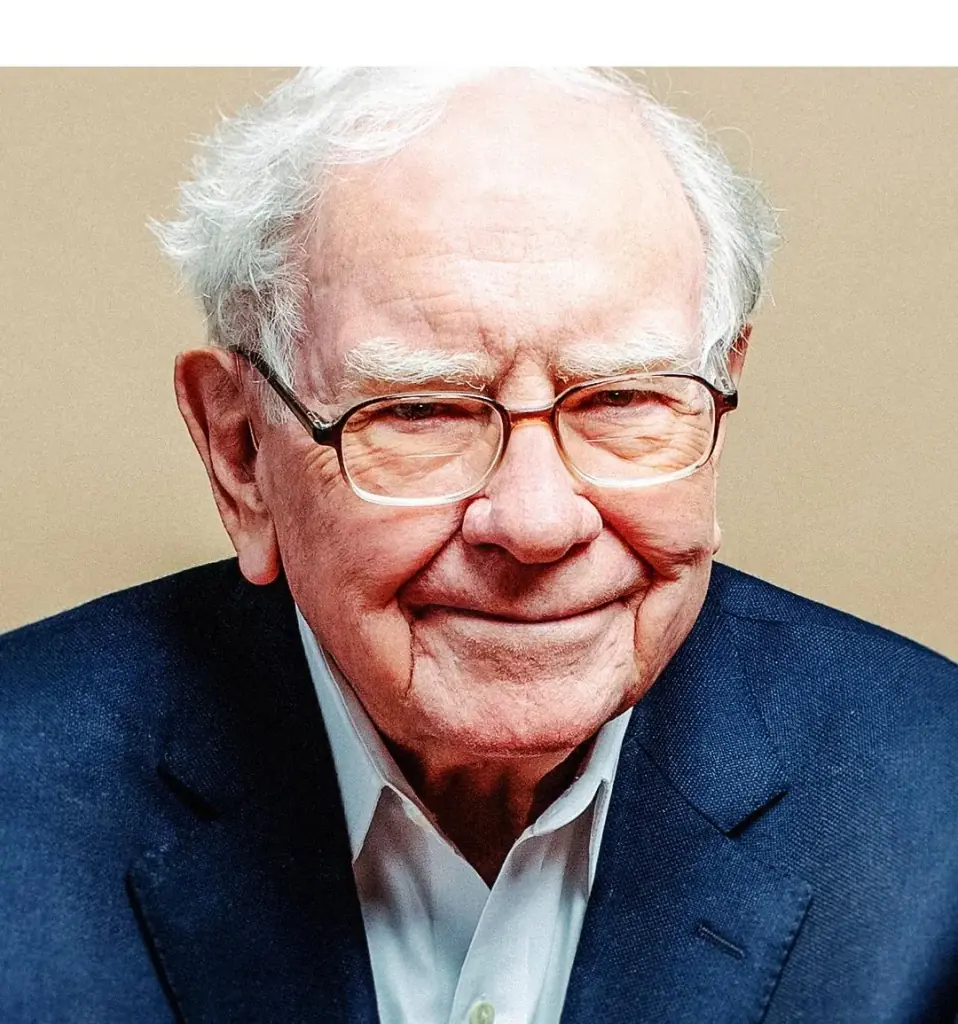 Retrato de un hombre mayor sonriente con cabello blanco y gafas. Viste un traje azul marino y camisa blanca, transmitiendo confianza.
