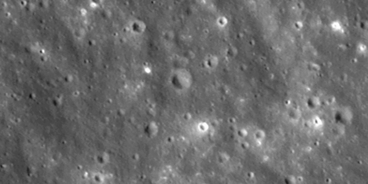 Imagen en escala de grises que muestra la superficie lunar llena de múltiples cráteres de impacto de diversos tamaños.