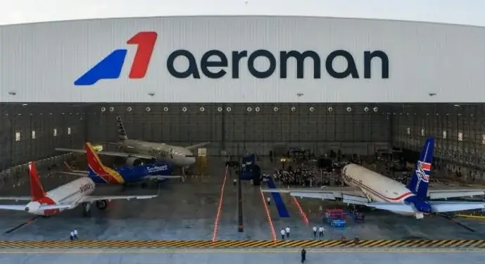 Vista exterior del gran hangar aeroman con múltiples aviones comerciales estacionados para mantenimiento.