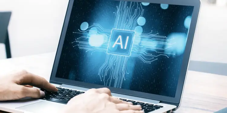 Primer plano de manos escribiendo en un portátil con una pantalla que muestra el logo de IA rodeado de circuitos digitales y luces bokeh azules.