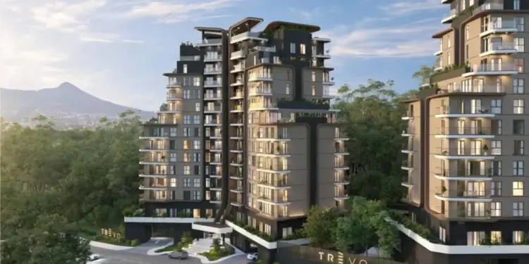 Render arquitectónico de complejos de edificios modernos con diseño vanguardista rodeados de vegetación y montañas al fondo.