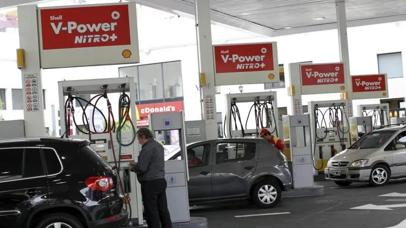 Vehículos cargando combustible en una estación de servicio con letreros de Shell V-Power NITRO+.