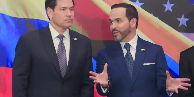 Dos hombres con trajes oscuros y corbatas discuten activamente frente a un fondo con los colores de la bandera de Estados Unidos y Venezuela.