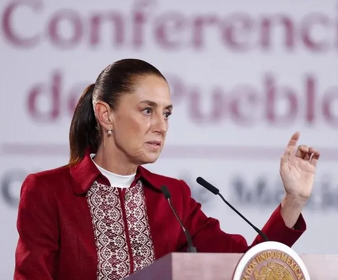 Mujer ejecutiva hablando en una conferencia de prensa frente a micrófonos.