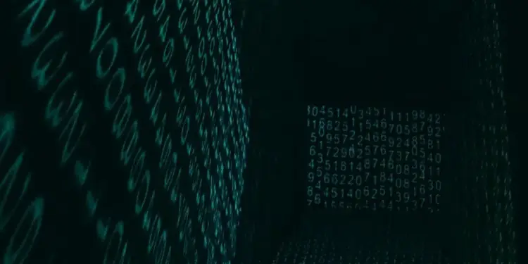 Espacio digital tridimensional con paredes y suelo formados por números brillantes en tono verde azulado sobre fondo negro.