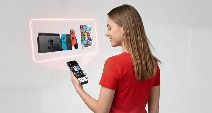 Mujer usando un teléfono inteligente junto a un cartel publicitario de Clarovideo y una consola de videojuegos.